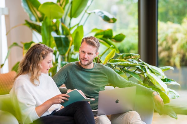 Two marketers are discussing marketing tactics for a client that they work with
