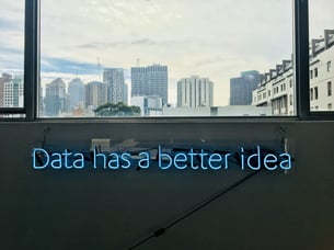 neon letters about hubspot data in front of a skyline